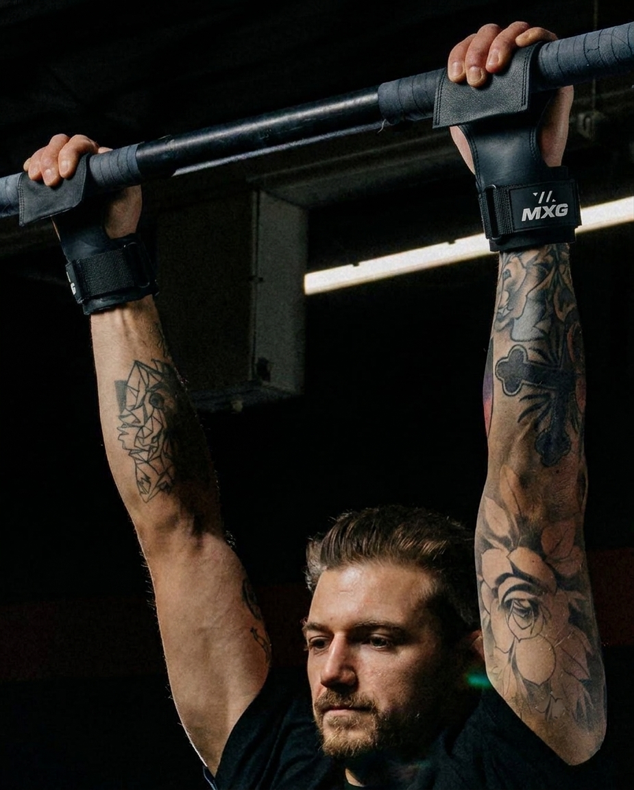 Athlete using lifting grips during pull-ups for grip strength training